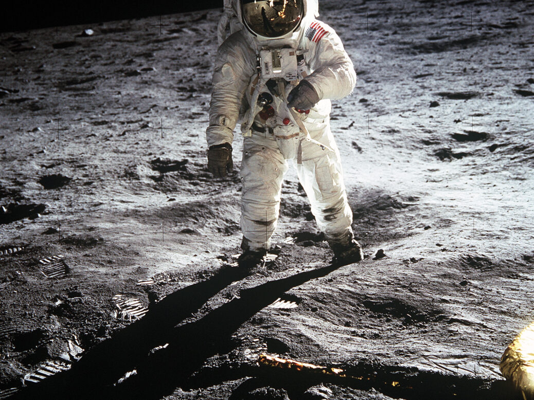 An artist's concept of a lunar base, with modules and solar panels, set against the barren lunar landscape