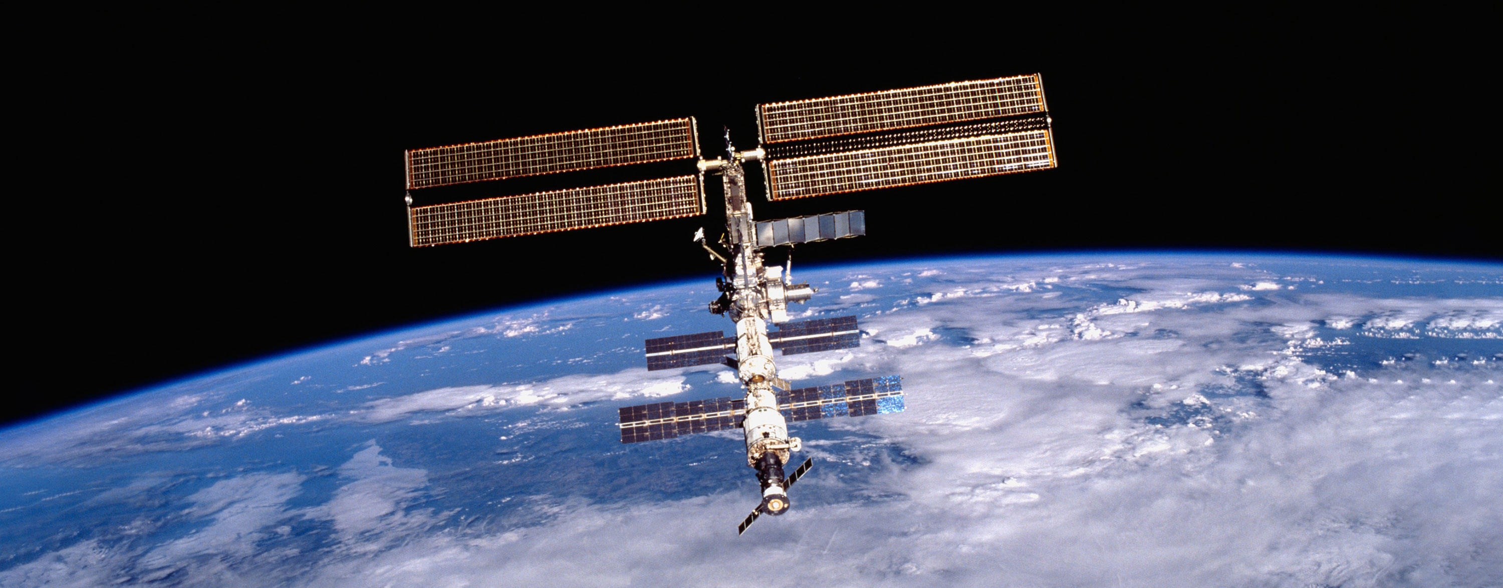 The International Space Station orbiting the Earth, with the blue planet filling the background